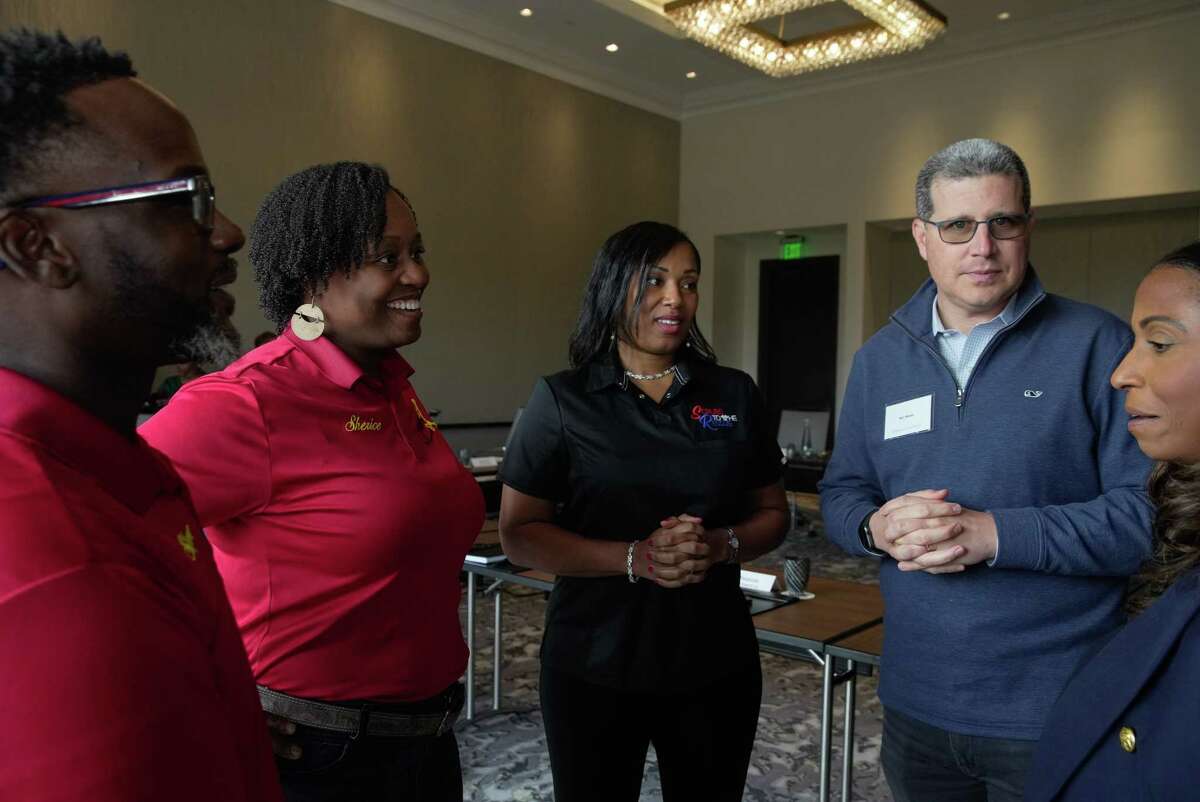 JPMorgan Chase & Co. Head of Community Banking and Business Development Diedra Porche, from right, CEO of Business Banking Ben Walter have a conversation with local small business owners Tennille Johnson, of Scrubs to the Rescue, and Steve and Sherice Garner, of Southern BBQ and Catering, after a roundtable Thursday, Nov. 17, 2022, at Post Oak Hotel in Houston.