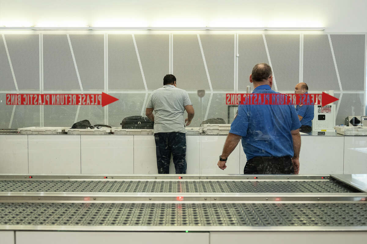 A traveler searches for his bag at the Automated Screening Lanes at SFO in San Francisco on November 16, 2022.