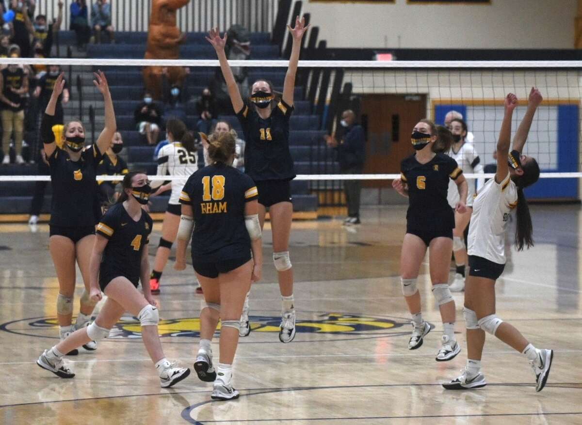 RHAM celebrates a point during it's 3-0 win over Simsbury in the CIAC Class L volleyball championship on Saturday, Nov. 20, 2021 at East Haven High School in East Haven, Conn.