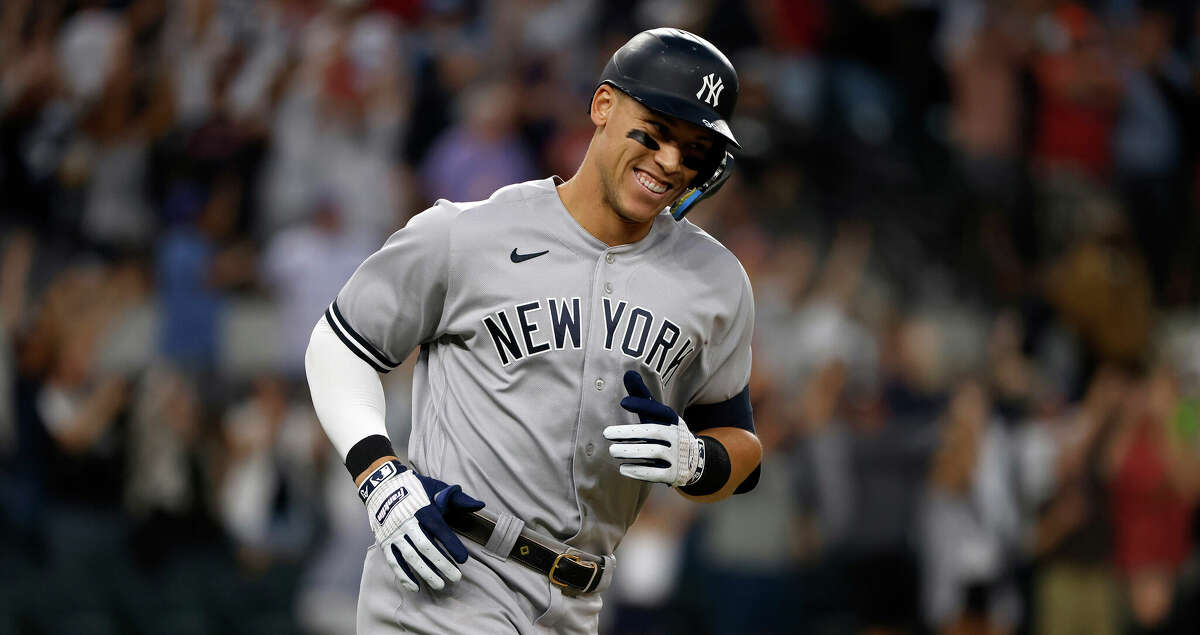 Aaron Judge of the New York Yankees smiles as he rounds the bases after hitting his American-League record 62nd home run of the season, against the Texas Rangers at Globe Life Field on October 4, 2022, in Arlington, Texas. (Ron Jenkins/Getty Images/TNS)