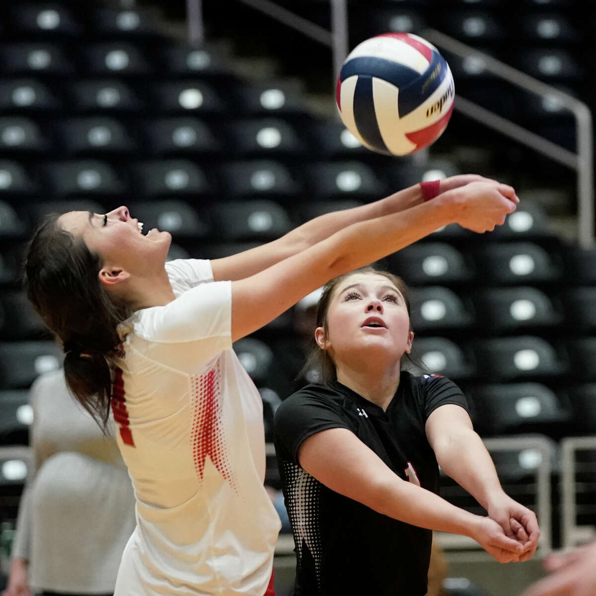 Huffman Hargrave's Erin Drvenkar, left, and Addison Shannon converge on the ball against Canyon Randall High School in their state semifinal volleyball match, won by Canyon Randle, on Wednesday, November 17, 2022 at the Curtis Culwell Center in Garland, Texas. CREDIT: Louis DeLuca for the Houston Chronicle