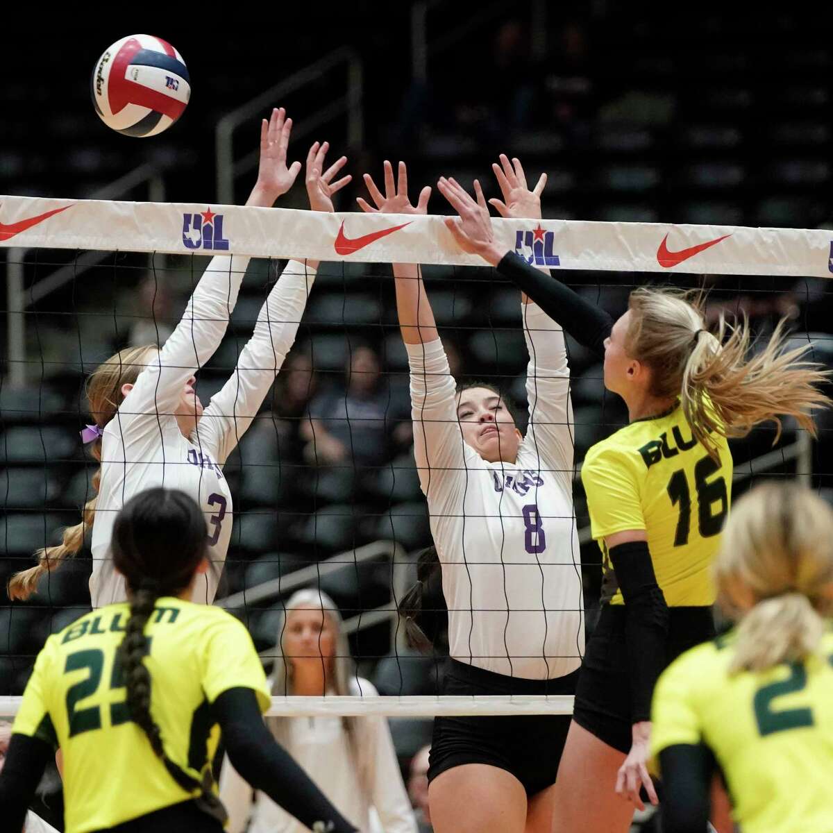 D’Hanis High School’s Jolie Frosch (3) and Peyton Burell (8) defend against Blum High School’s Emma Scott in their state final volleyball match on Wednesday, November 17, 2022 at the Curtis Culwell Center in Garland, Texas. CREDIT: Louis DeLuca for the San Antonio Express News