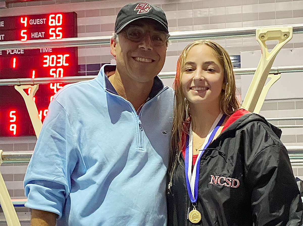 New Canaan's Kaitlyn Maggio, picture with coach Joe Somma, won the State Open diving championship in Middletown on Thursday, Nov. 17, 2022.