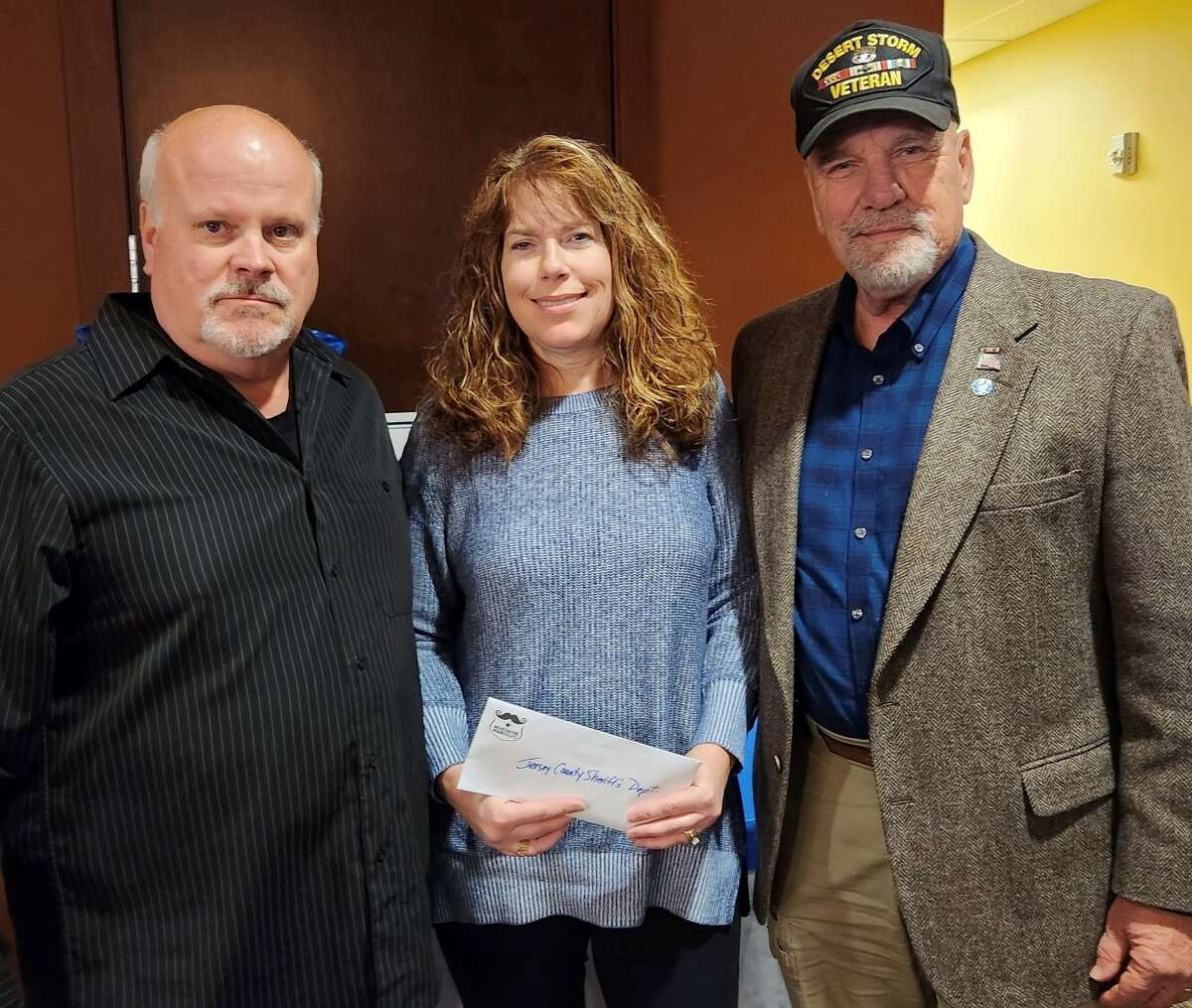Left to right, Grafton Police Chief Eric Spanton, Jersey County Sheriff’s Department's  Cindy Wagner and Grafton Mayor Mike Morrow at the annual Mustache March 4PD Committee appreciation awards ceremony Wednesday. 