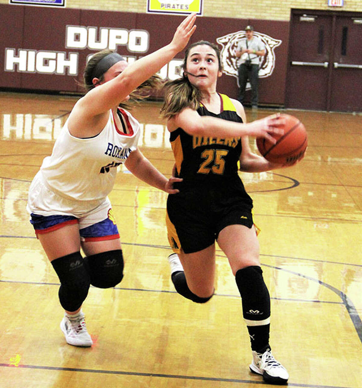 EA-WR's Milla LeGette (right) takes the ball to the basket against Roxana's Kinsley Mouser on Thursday night in a semifinal at the Cat Classic in Dupo.