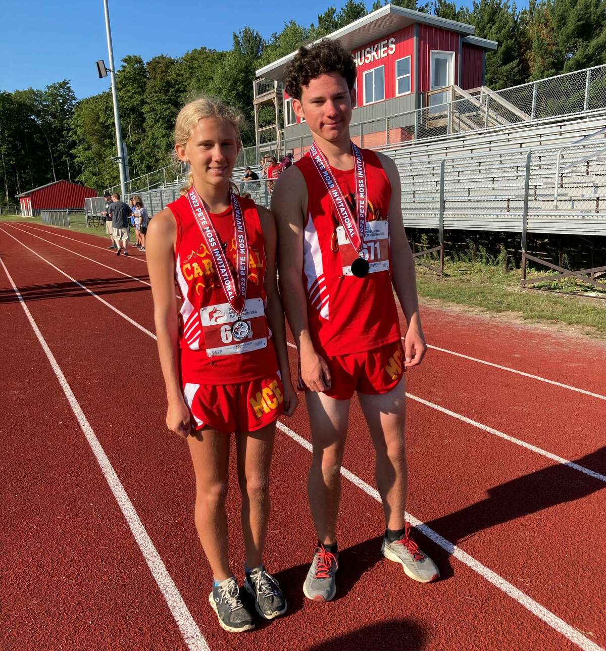 Lauren (left) and Luke Niedzielski stand for a photo with their medals following the 2022 Benzie Central Pete Moss Invitational at Benzie Central High School on Aug. 26. 