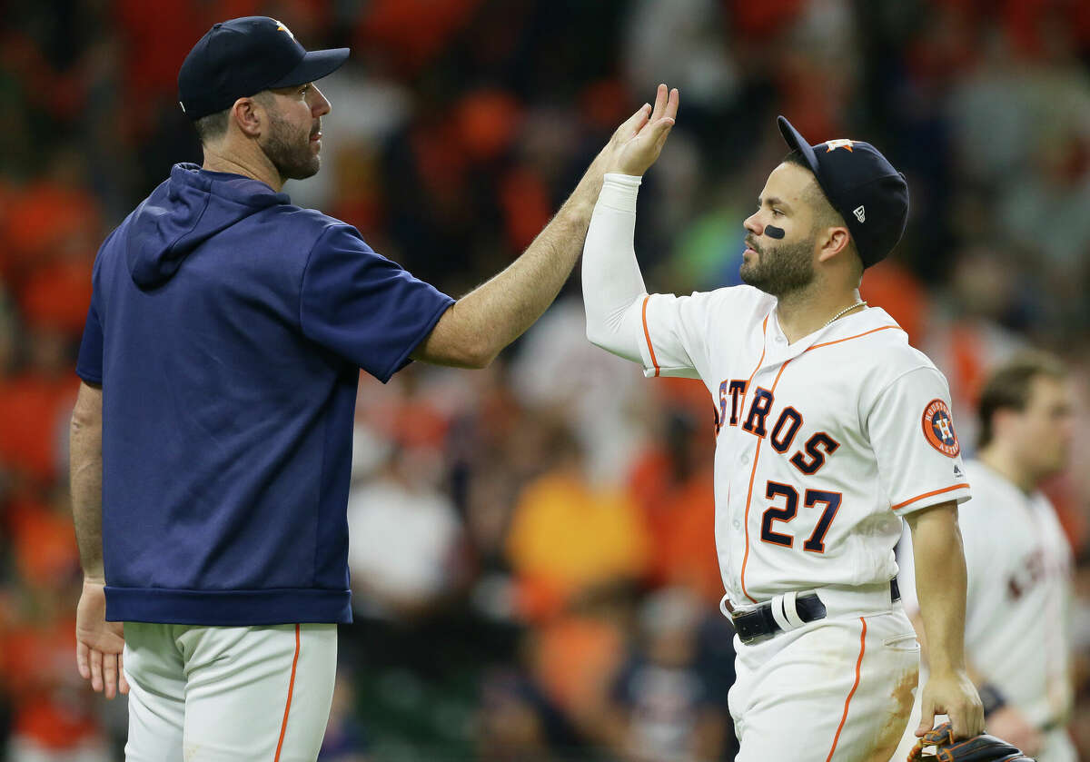 Jose Altuve #27 of the Houston Astros high fives Justin Verlander #35 after defeating the Colorado Rockies at Minute Maid Park on August 06, 2019 in Houston, Texas. (Photo by Bob Levey/Getty Images)