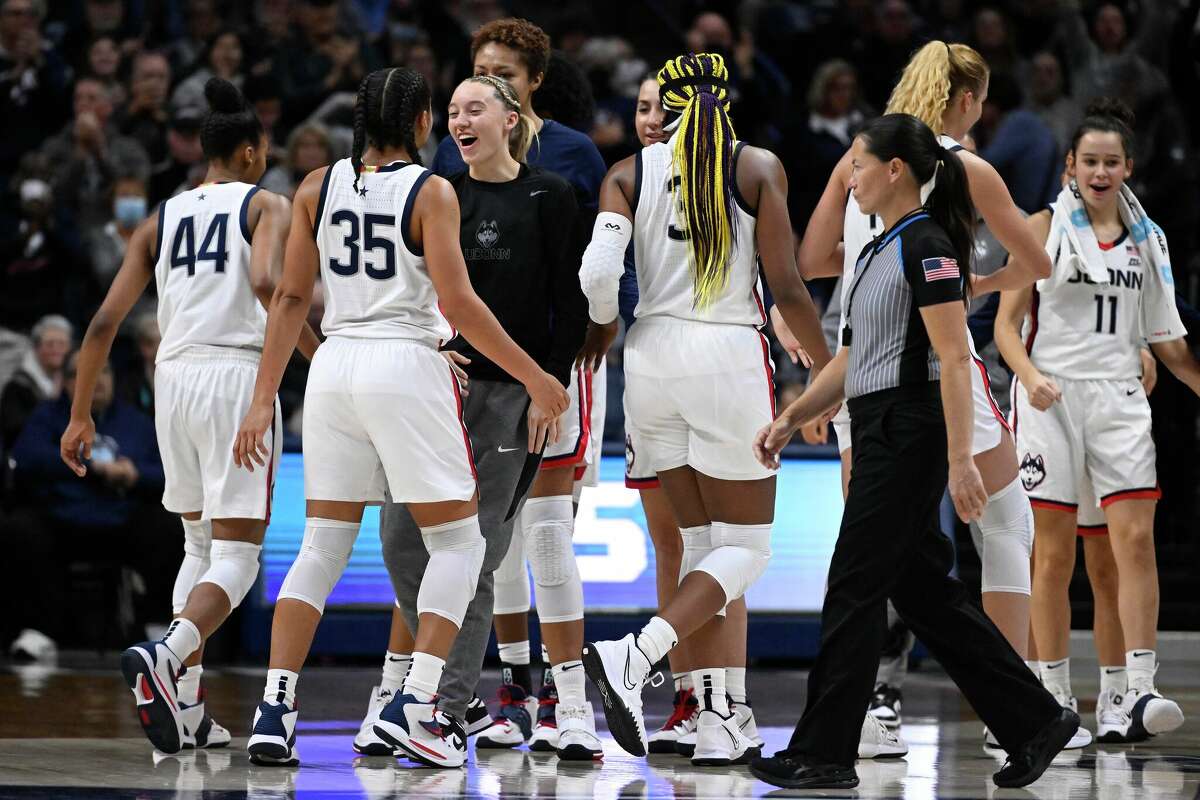 Connecticut's Paige Bueckers celebrates with teammate Azzi Fudd (35) during the second half of an NCAA college basketball game against Texas, Monday, Nov. 14, 2022, in Storrs, Conn. (AP Photo/Jessica Hill)