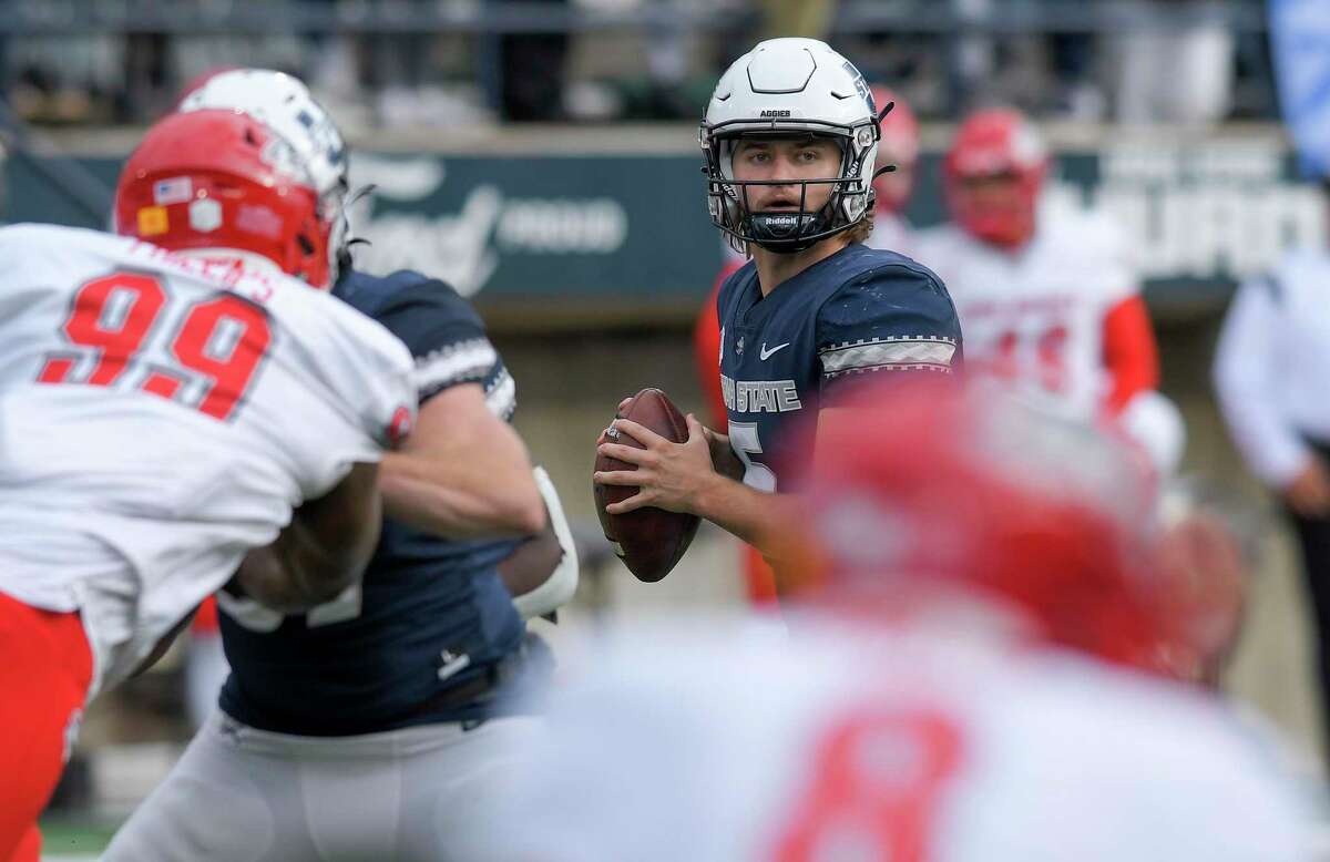 Utah State quarterback Cooper Legas (5) looks to throw the ball against New Mexico during the second half of an NCAA college football game Saturday, Nov. 5, 2022, in Logan, Utah. (Eli Lucero//The Herald Journal via AP)