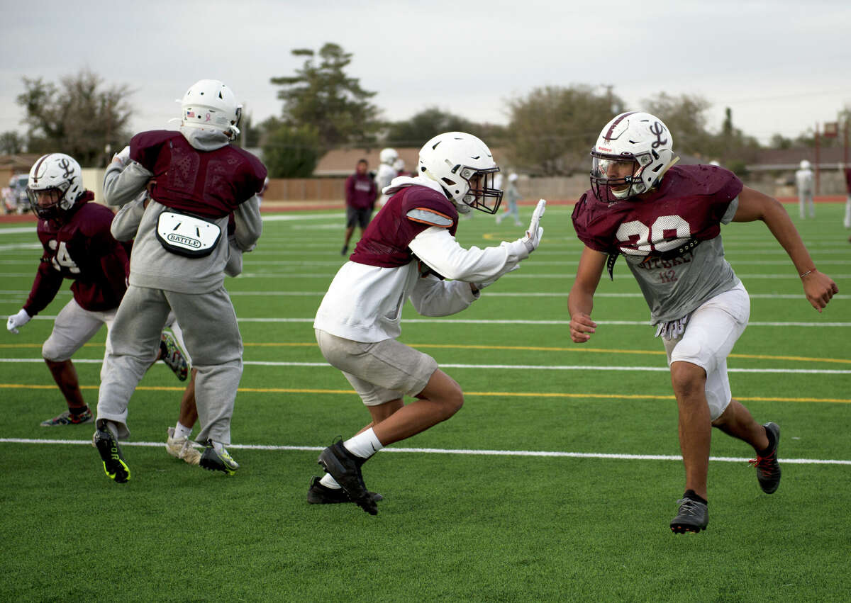 Legacy junior Gilbert Hernandez (39, far right) comes off the edge during a punt drill, Nov. 16 at Rebel Field. 