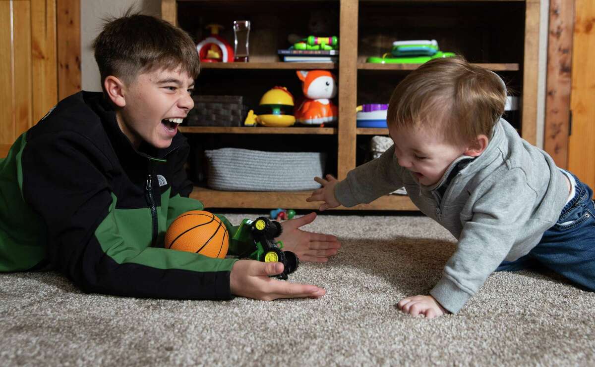 Ripp Macek, 16 months, plays with his brother, Parks Macek, 14, Friday, Nov. 18, 2022, in El Campo. Ripp was nearly killed in a tractor accident in September, and was flown by LifeFlight to the Texas Medical Center. Ripp has had an amazing recovery at TIRR, and was discharged in early November.