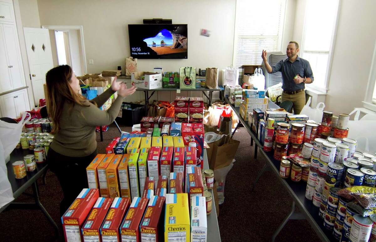 William Brucker, Chief Advancement Officer at Family Centers, works on the annual Thanksgiving Day food drive at the organization's offices in Greenwich, Conn., on Friday November 18, 2022. Helping out, at left, is employee Karissa Payero. Family Centers is a major nonprofit based in Greenwich that serves people in need in southeastern Fairfield County with health care services, mental health services, early childhood education, job training, bereavement and more.