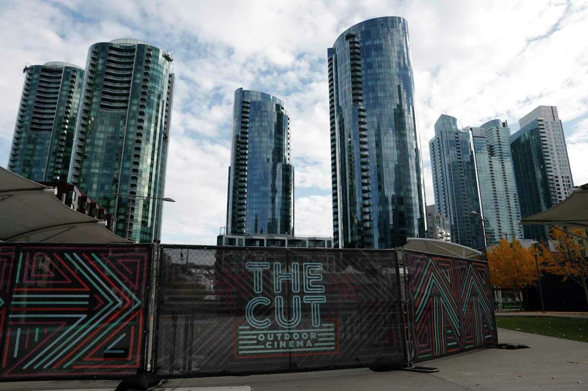 Buildings in the East Cut neighborhood are seen behind signage for The Cut Outdoor Cinema at the Temporary Transbay Terminal in San Francisco.