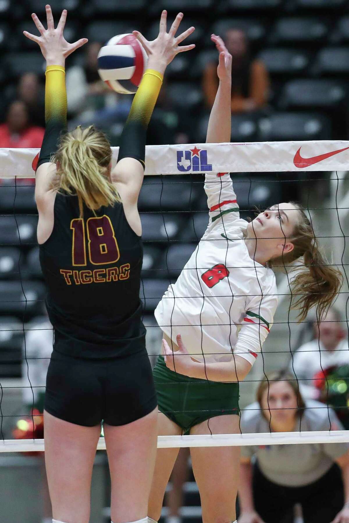 The Woodlands' Makenzie Weddel (8) gets a shot past Dripping Springs' Ava Williamson (18) in the first set of a Class 6A state semifinal match during the UIL State Volleyball Championships at the Curtis Culwell Center, Friday, Nov. 18, 2022, in Garland.