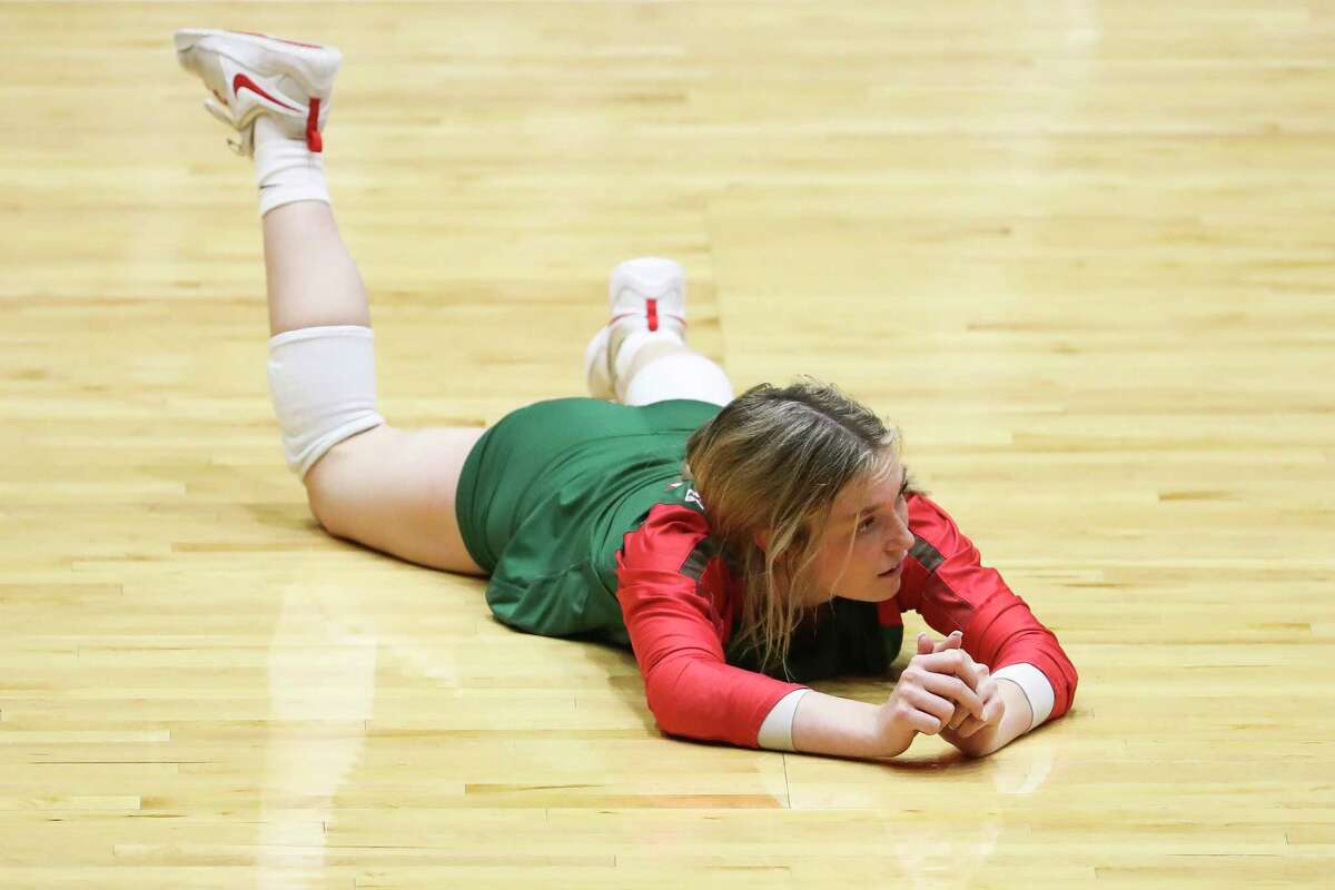 The Woodlands' Molly Tuozzo (12) watches her dig sail out of bounds for the final point of the third set of a Class 6A state semifinal match during the UIL State Volleyball Championships at the Curtis Culwell Center, Friday, Nov. 18, 2022, in Garland.