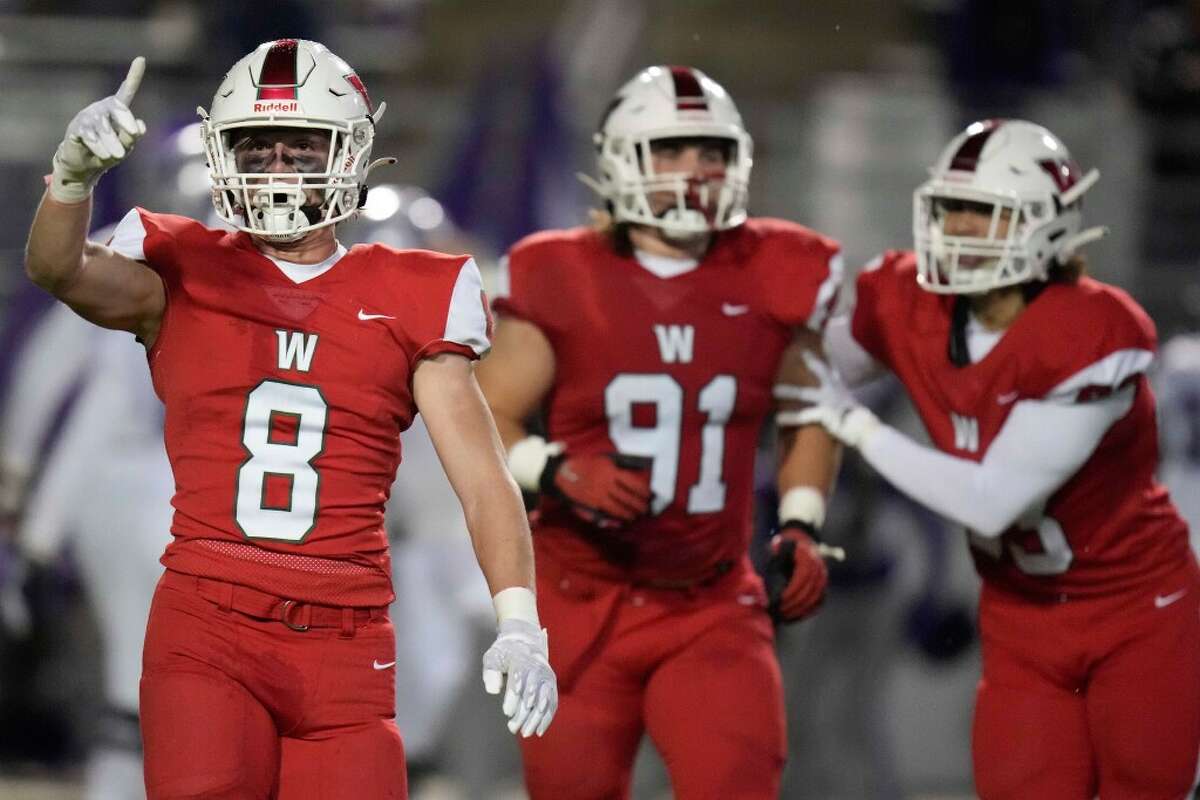 The Woodlands defensive back Brady Carlin (8) celebrates the fumble recovery of defensive lineman Steele Herndon (91) during the first half of a Region II-6A Division I area high school football playoff game against Klein Cain, Friday, Nov. 18, 2022, in The Woodlands.