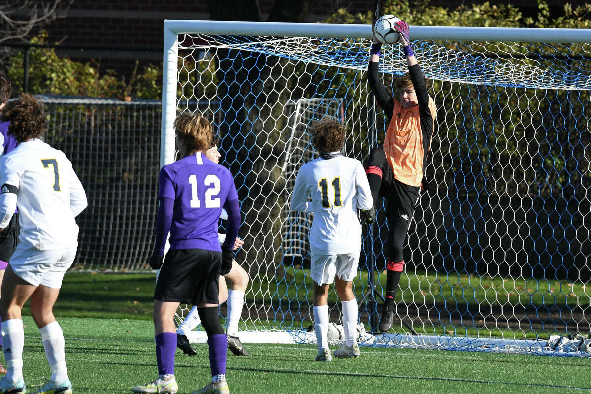 Ellington's Cole Leavitt makes a save from a save during the Boys' Grade M soccer final between Ellington and Weston at Trinity Health Stadium on Saturday November 19, 2022.