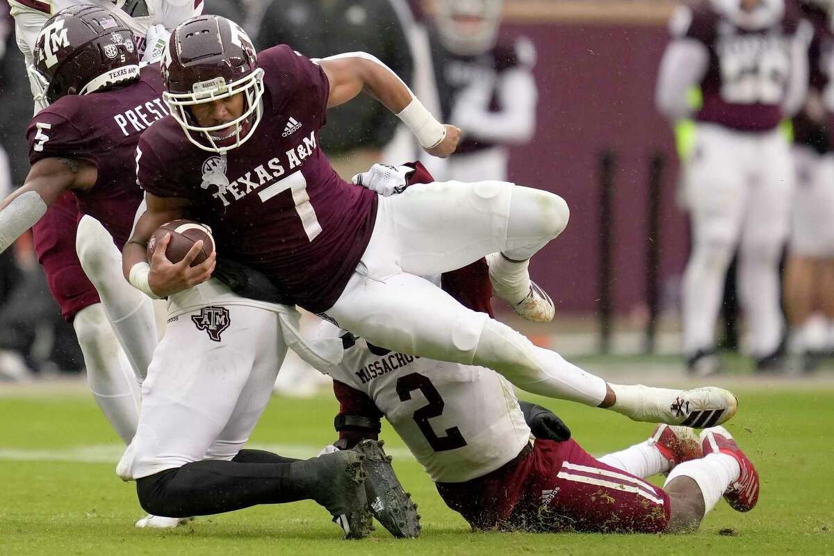 Texas A&M wide receiver Moose Muhammad III (7) is tackled by Massachusetts defensive back Tyler Rudolph (2) after a first down catch and run during the second half of an NCAA college football game, Saturday, Nov. 19, 2022, in College Station, Texas. (AP Photo/Sam Craft)