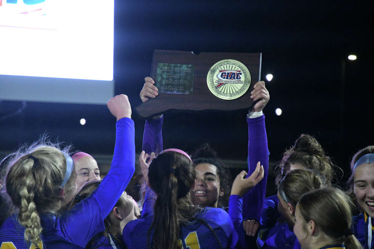 Mercy's Melina Ford holds up the championship plaque after winning the Class M girls soccer championship against Northwest Catholic at Trinity Health Stadium on Saturday, Nov. 19, 2022.