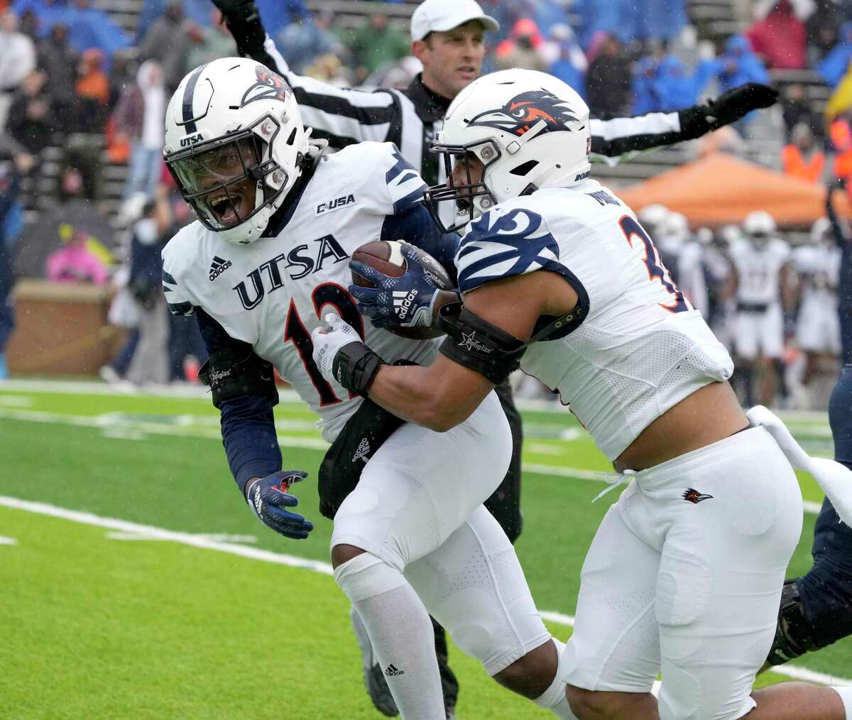 UTSA linebacker Donyai Taylor, left, celebrates with teammate Trey Moore after returning a fumble for a touchdown during the first half of Saturday’s game against Rice in Houston.