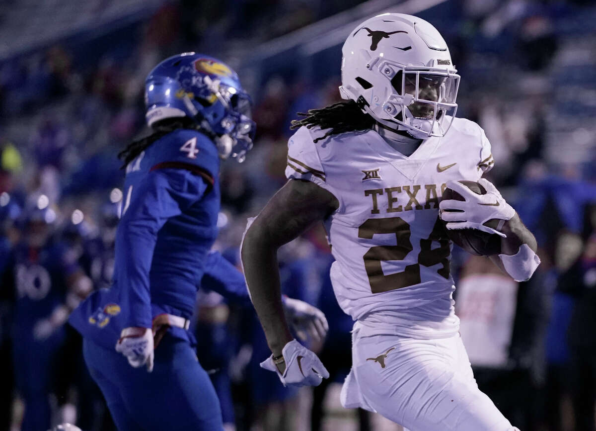 LAWRENCE, KANSAS - NOVEMBER 19: Running back Jonathon Brooks #24 of the Texas Longhorns runs in for a touchdown against safety Marvin Grant #4 of the Kansas Jayhawks in the second half at David Booth Kansas Memorial Stadium on November 19, 2022 in Lawrence, Kansas. (Photo by Ed Zurga/Getty Images)