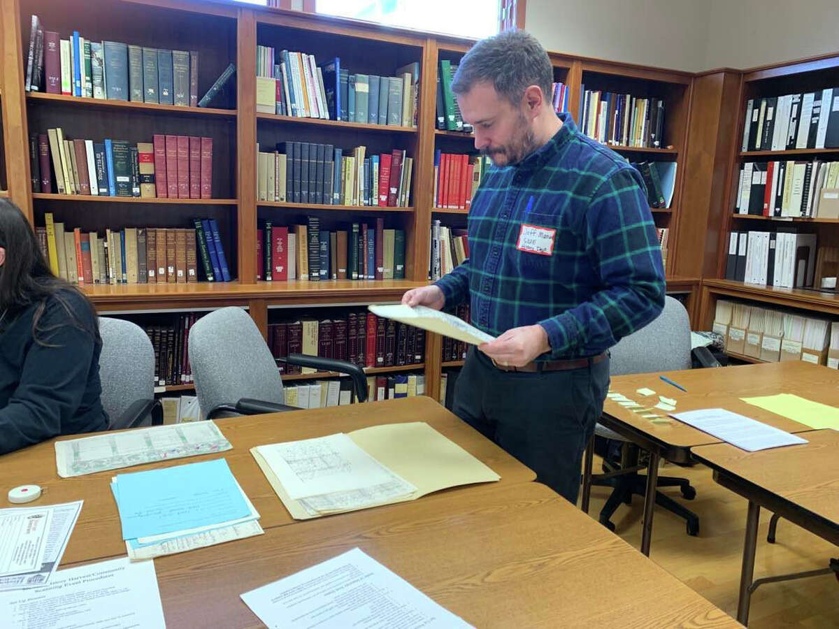 Dr. Jeff Manuel looks over documents at the Madison County Historical Society's History Harvest. 
