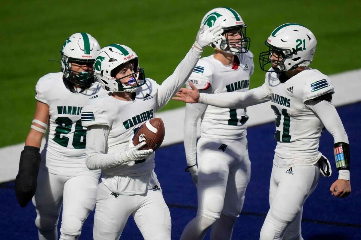 The Woodlands Christian Academy defensive back Josh Johnson, second from left, celebrates his interception during the second half of a TAPPS Division II area high school football playoff game against Second Baptist, Saturday, Nov. 19, 2022, in Houston.