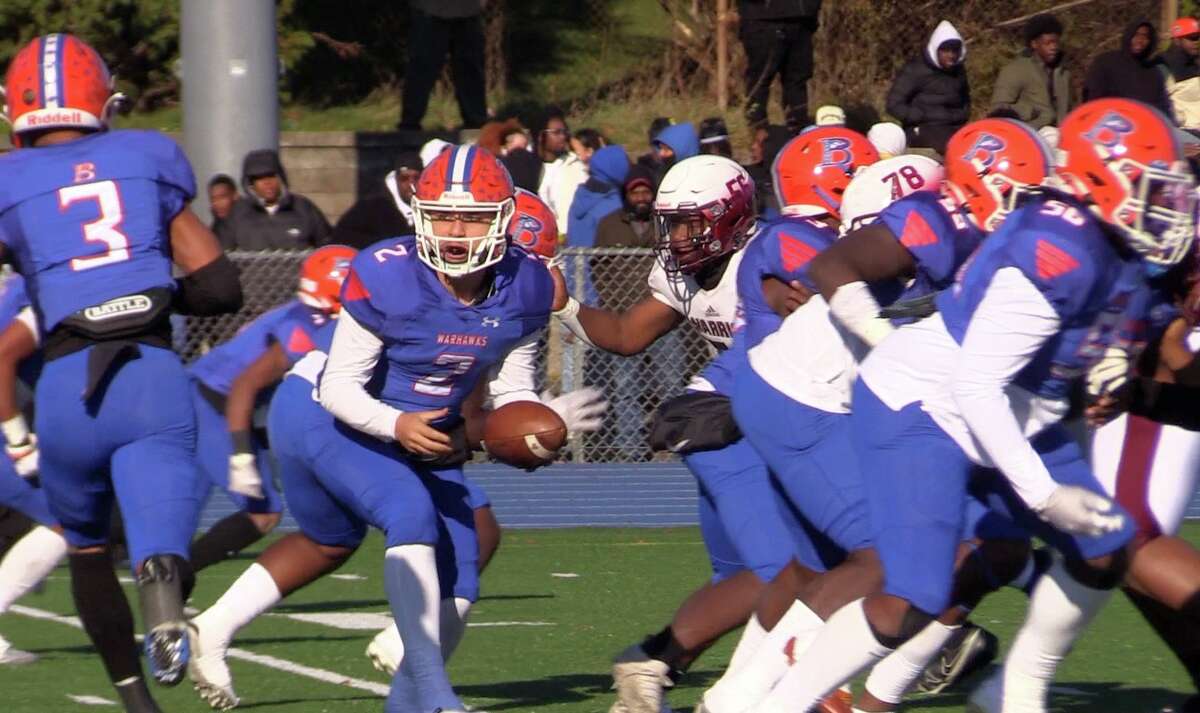 Bloomfield quarterback Darrien Foster looks to hand off to Davien Kerr (3) during Bloomfield's 16-12 victory over Windsor at Phil Rubin Stadium in Bloomfield, Saturday, Nov. 19, 2022.