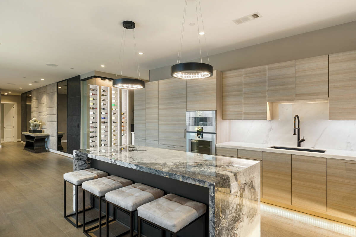 The chef's kitchen has a marble waterfall countertop.
