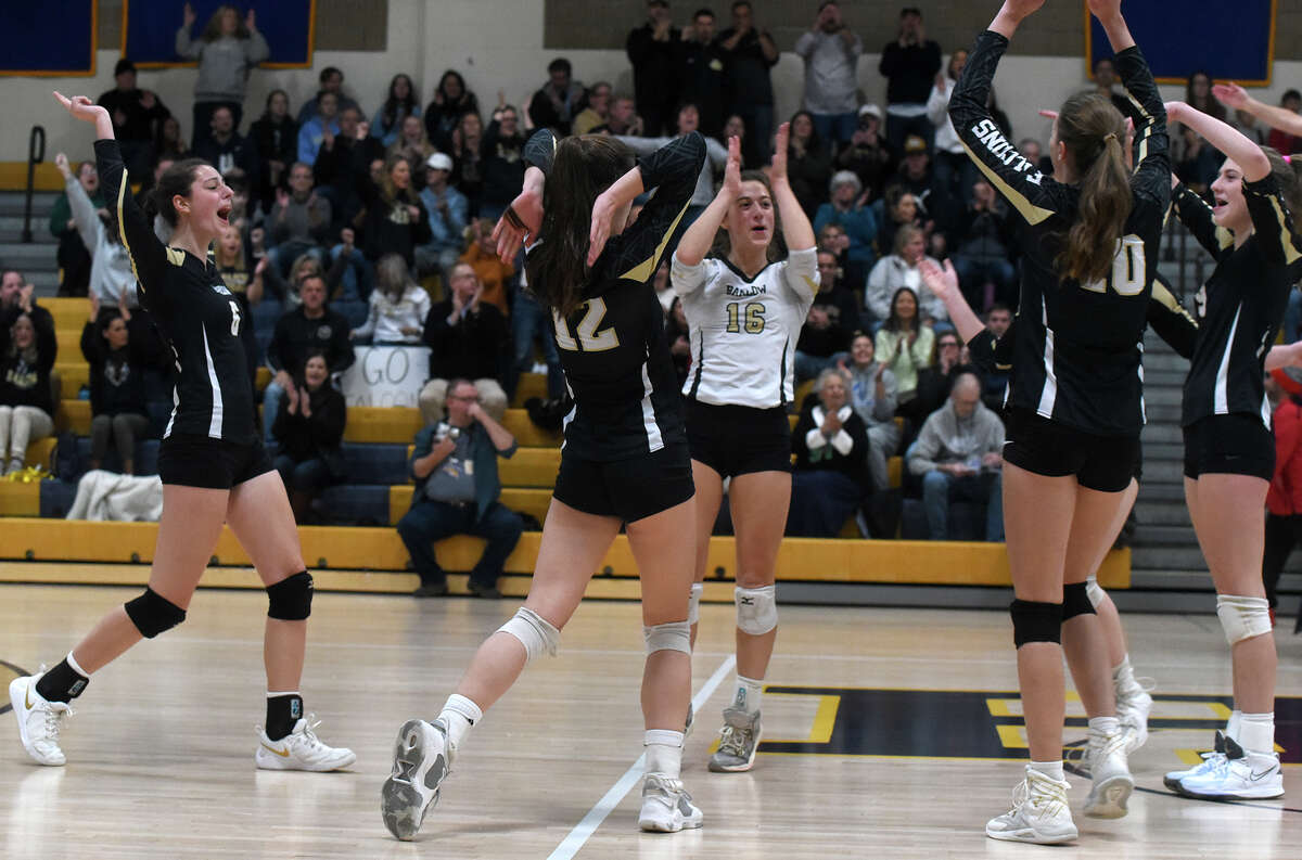 Joel Barlow players celebrate a point against Bristol Central during the CIAC Class L girls volleyball final in East Haven on Saturday, Nov. 19, 2022.