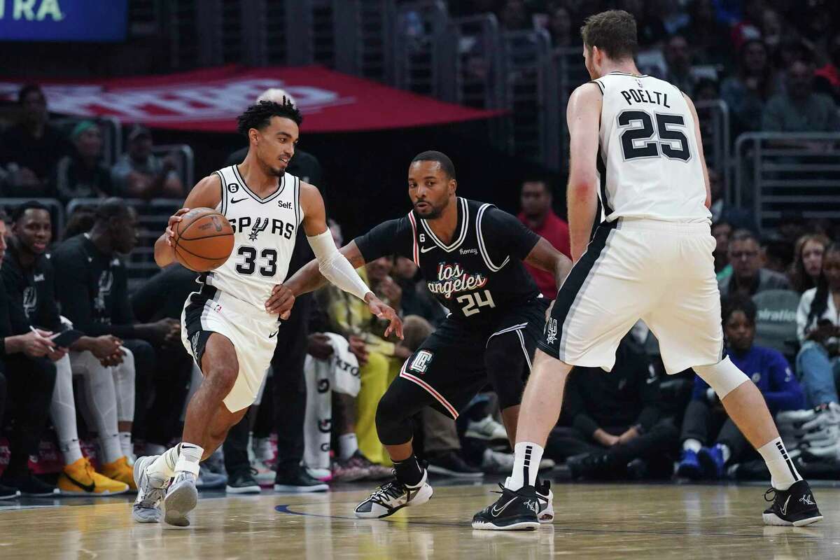 Clippers forward Norman Powell defends against the Spurs' Tre Jones during the first half of Saturday’s game in Los Angeles.