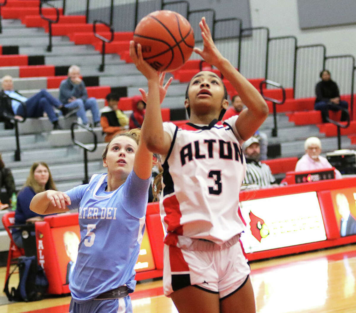 Alton's Kiyoko Proctor (3) goes up for two of her 15 points after getting past Breese Mater Dei's Madison Winkeler in the Alton Tournament on Saturday night in Godfrey.