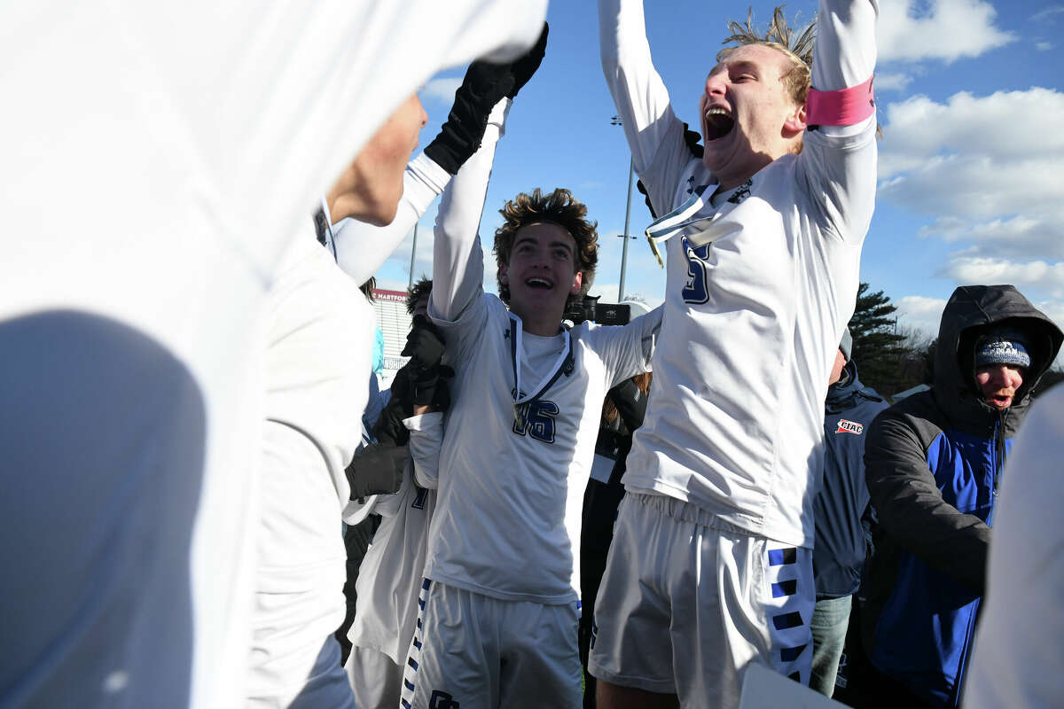 Old Saybrook's Kevin DeCapua holds up the championship plaque after Old Saybrook beat East Hamption in the Class S boys soccer championship at Trinity Health Stadium on Sunday, Nov. 30, 2022.