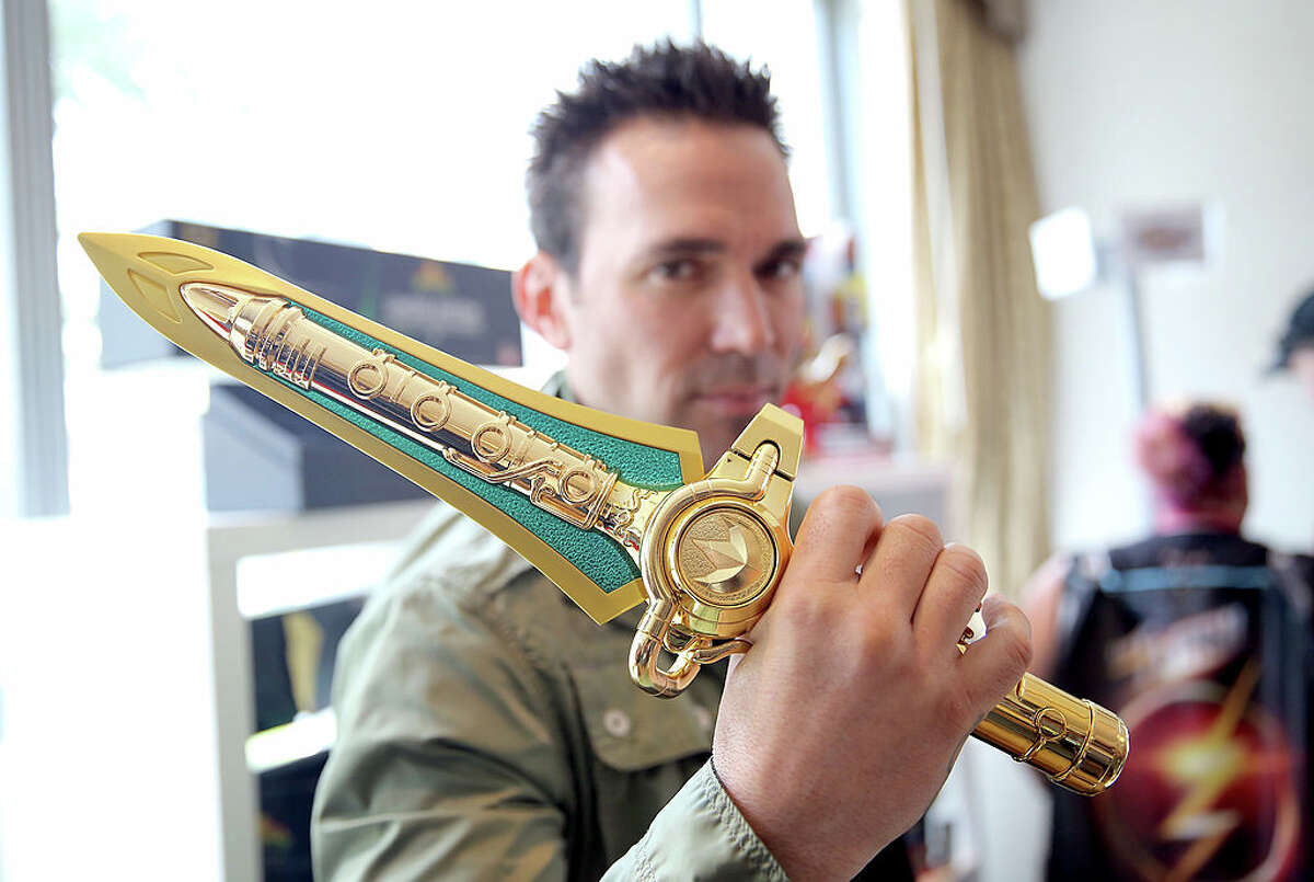 SAN DIEGO, CA - JULY 25: Actor Jason David Frank, the original Green Mighty Morphin Power Ranger poses with BandaiÂ?’s Comic-Con Exclusive Limited Edition Legacy Dragon Dagger at the Power Rangers media suite during San Diego Comic-Con International on July 25, 2014 in San Diego, CA. (Photo by Chelsea Lauren/Getty Images for Saban Brands)