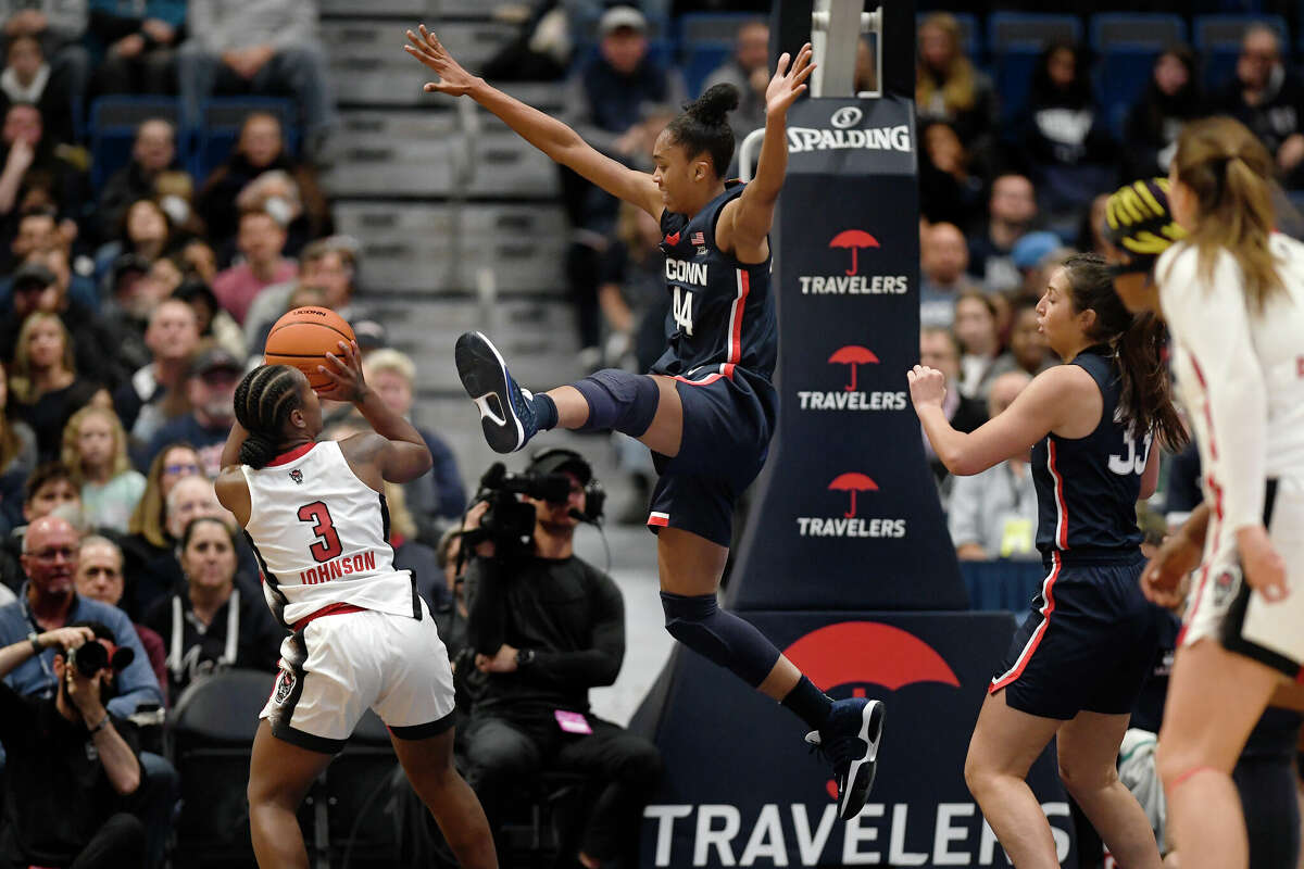NC State's Diamond Johnson (3) shoots as Connecticut's Aubrey Griffin (44) defends during the first half of an NCAA basketball game, Sunday, Nov. 20, 2022, in Hartford, Conn,
