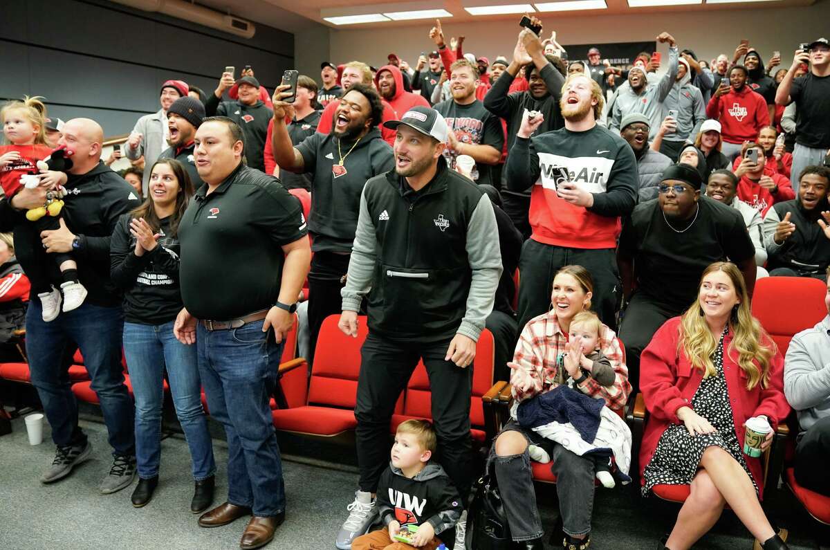 UIW head coach G.J. Kinne, along with UIW Athletic Director Richard Duran, reacts during the team’s selection show watch party late Sunday morning on the campus. The Cardinals drew a first round bye.