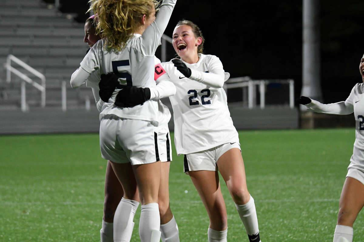 Staples' Neva Mermagen celebrates with teammates after Staples beat Cheshire in the Class LL girls soccer state championship at Trinity Health Stadium on Sunday, Nov. 30, 2022.