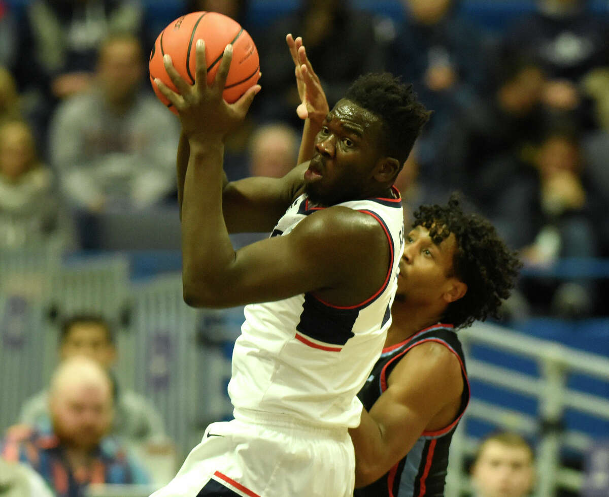 UConn forward Adam Sanogo, left, grabs a rebound over Delaware State's Kyle Johnson in the NCAA men's college basketball game between No. 25 UConn and Delaware State at the XL Center in Hartford, Conn. Sunday, Nov. 20, 2022.