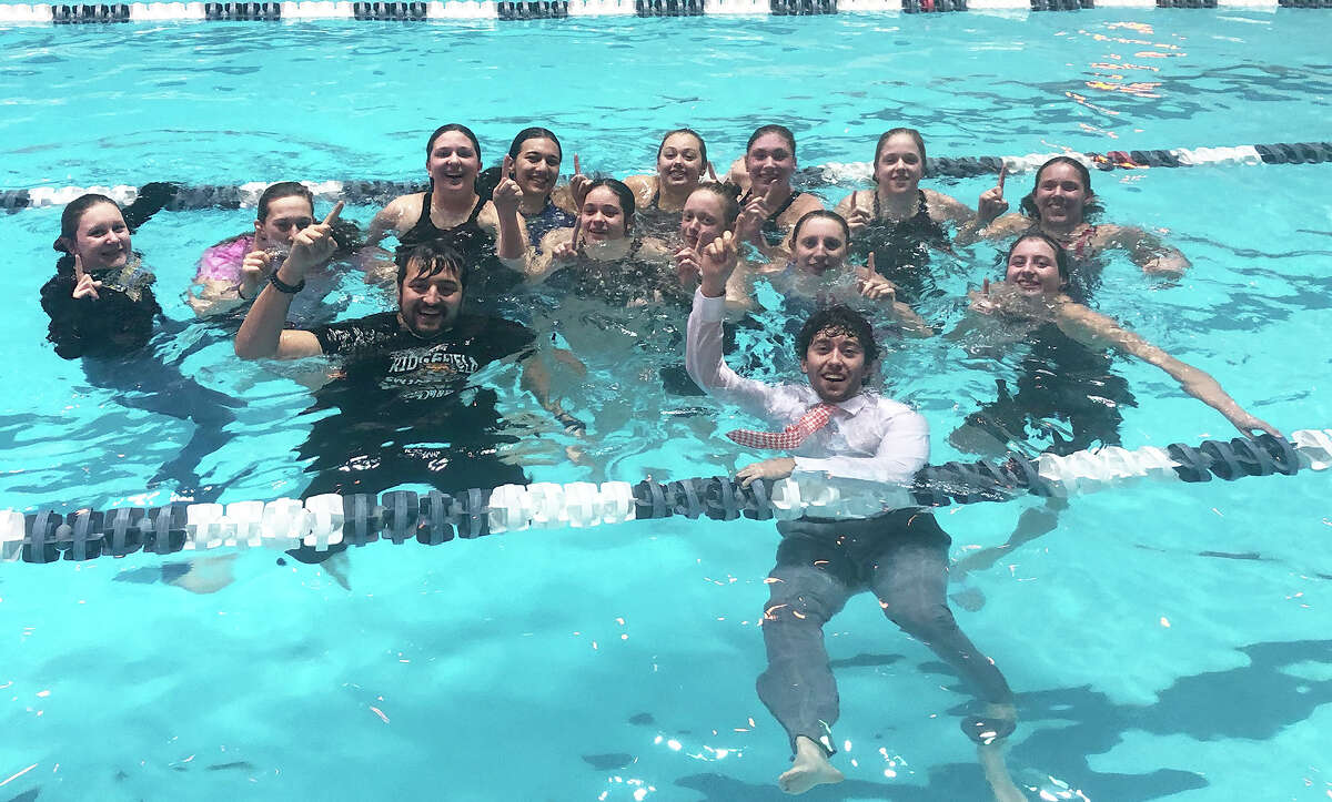 Ridgefield swimmers and coaches celebrate in Yale's Kiphuth Pool iafter winning the program's first CIAC State Open girls swimming diving championship on Sunday, Nov. 20, 2022.