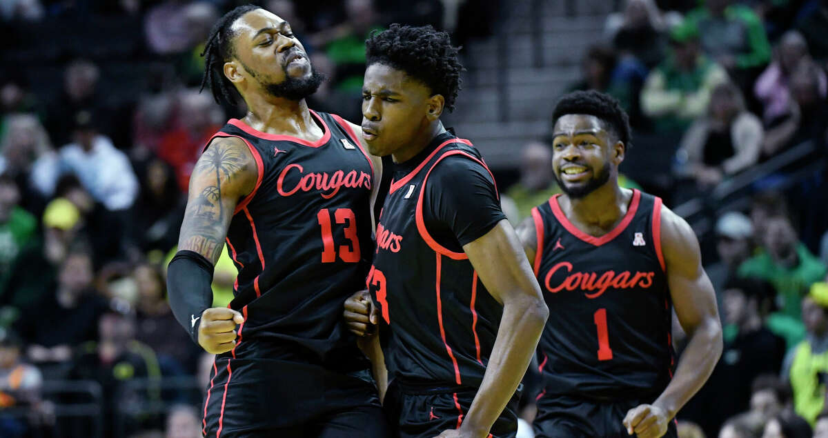 Houston guard Terrance Arceneaux (23) celebrates his 3-point shot against Oregon with forward J'Wan Roberts (13) and Houston guard Jamal Shead (1) during the first half of an NCAA college basketball game Sunday, Nov. 20, 2022, in Eugene, Ore. (AP Photo/Andy Nelson)