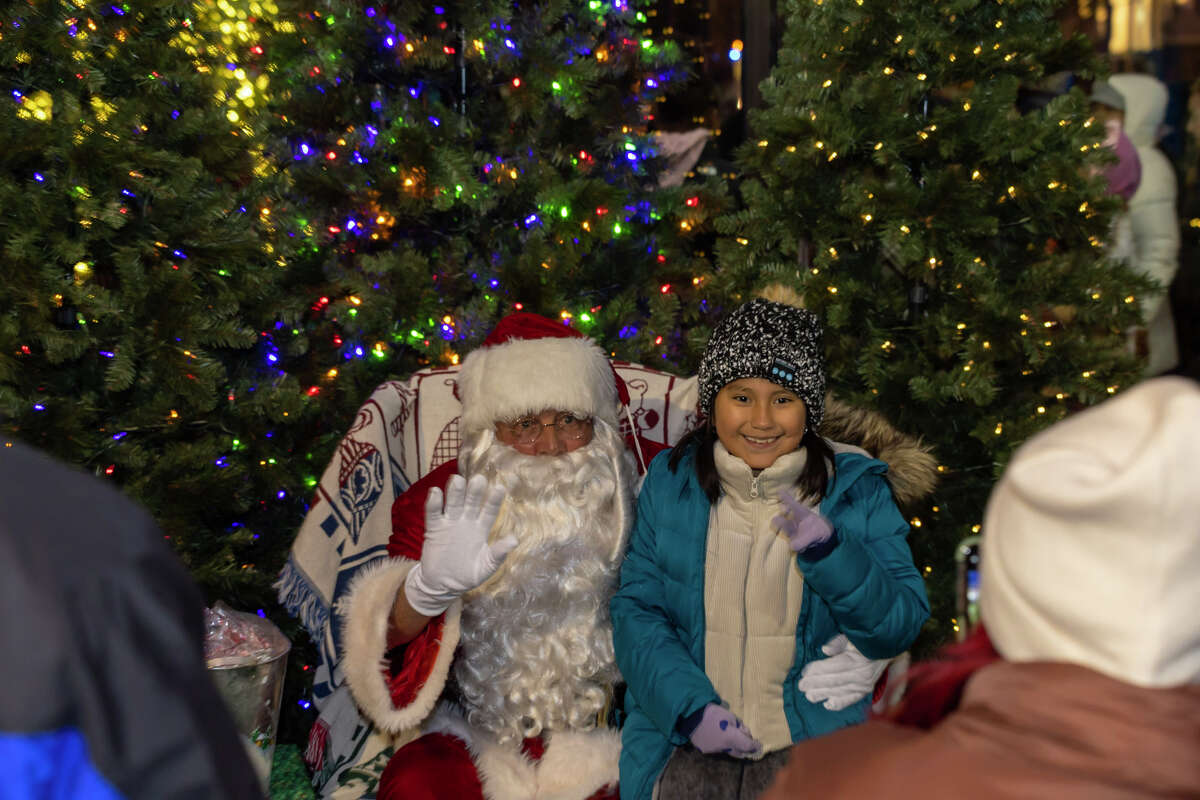 Children say with Santa at the first SoNo Holiday Extravaganza. The event included tree and menorah lighting ceremonies and other family activities.