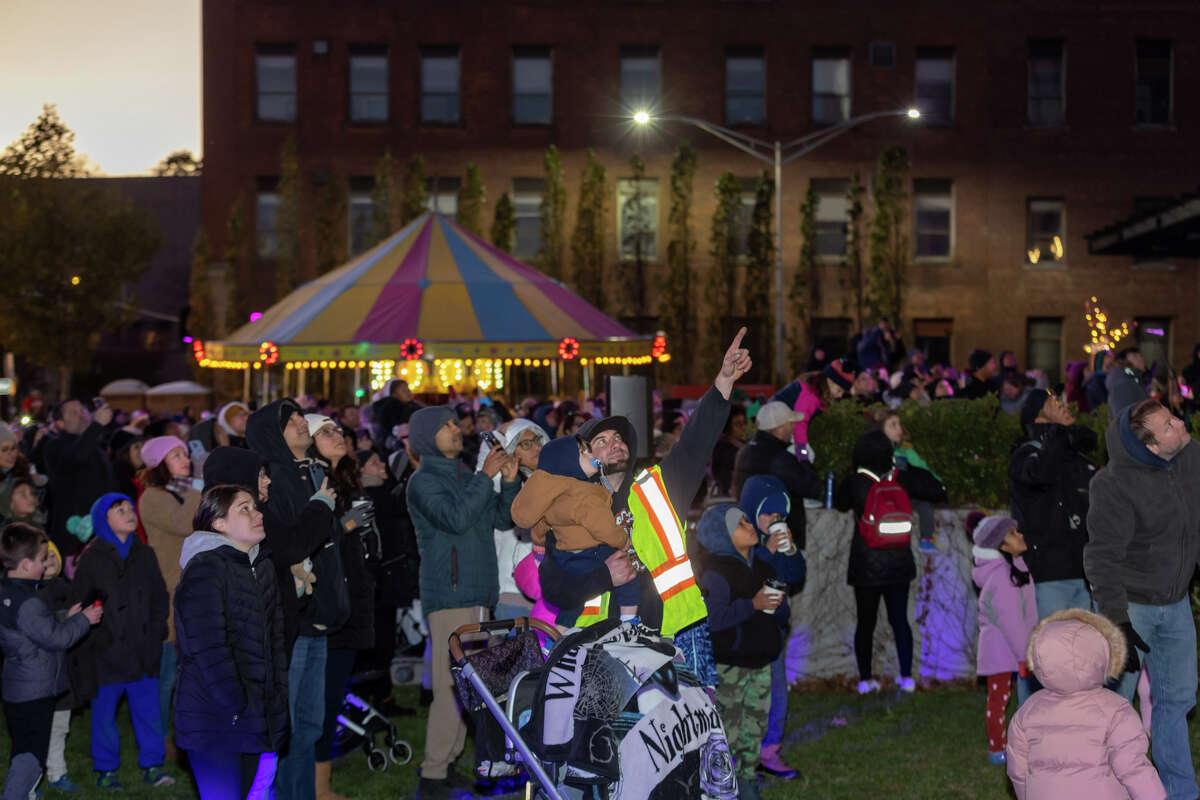 A crowd gathers outside 50 Washington Street on Sunday for the first SoNo Holiday Extravaganza. The event included tree and menorah lighting ceremonies and other family activities.