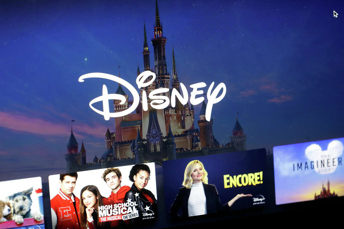 FILE - In this Wednesday, Nov. 13, 2019, file photo, a Disney logo forms part of a menu for the Disney Plus movie and entertainment streaming service on a computer screen in Walpole, Mass. Streaming services ranging from Netflix to Disney+ want us to stop sharing passwords. That's the new edict from the giants of streaming media, who hope to discourage the common practice of sharing account passwords without alienating their subscribers, who've grown accustomed to the hack. (AP Photo/Steven Senne, File)
