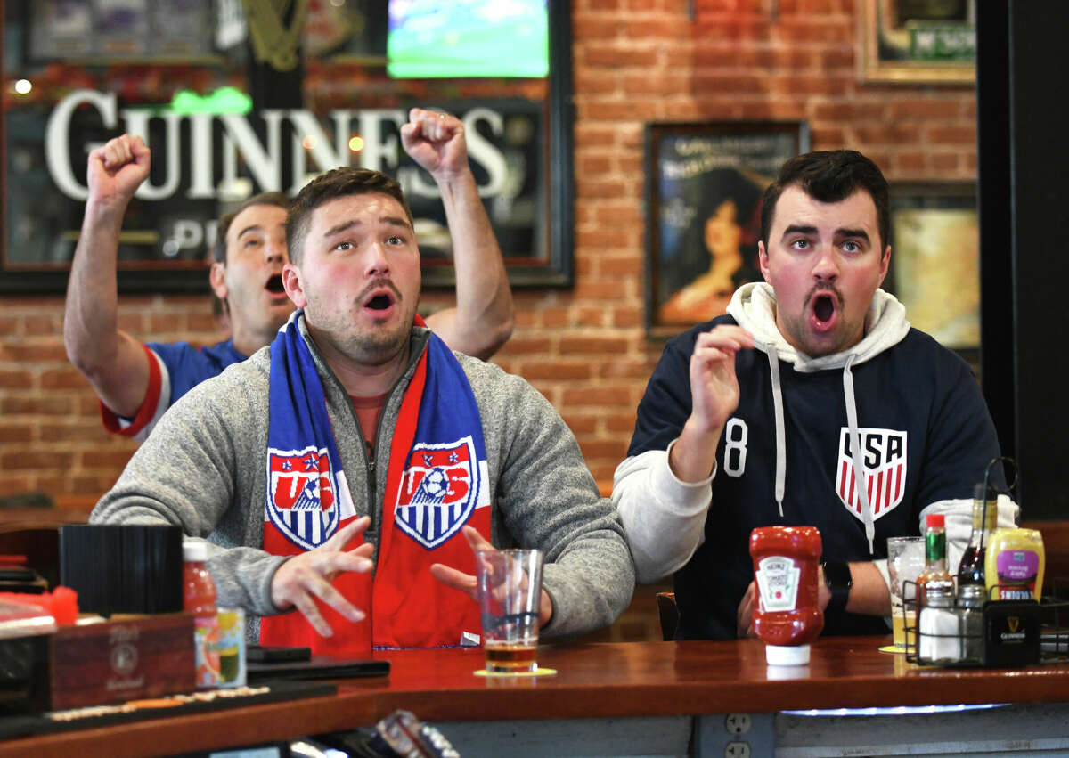 Stamford's Nick Dedrick, left, and Tyler Trzcinski react to a near goal in the World Cup soccer match between USA and Wales at Tiernan's Bar & Restaurant in Stamford, Conn. Monday, Nov. 21, 2022. Team USA will continue its matchups between Group B opponents England on Nov. 25 and Iran on Nov. 29.