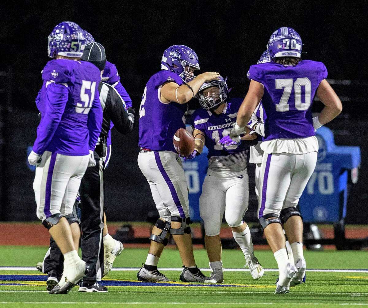 Boerne’s TJ Dement, send from right, celebrates one of his first half touchdown Friday night, Nov. 18, 2022 at Alamo Heights Stadium during the Greyhound’s’ game against the Pleasanton Eagles.