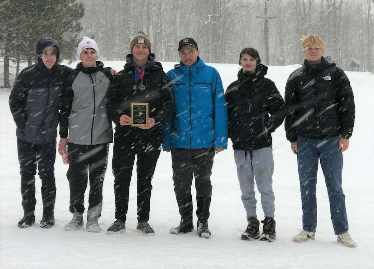 The Onekama ski team poses with a trophy they won during the 2021-22 season. 