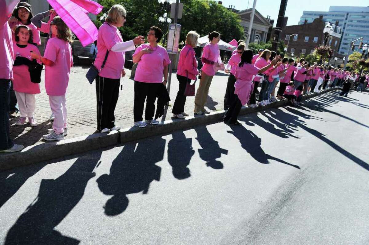 Family members. friends and breast cancer survivors gather along Atlantic Street in Stamford earlier this month to create a 'Mile of Pink.' The third annual 'Mile of Pink' is a 90-minute show of unity and a demonstration of breast cancer awareness. The event kicks off Stamford Hospital's month-long annual 'Paint the Town Pink' campaign.