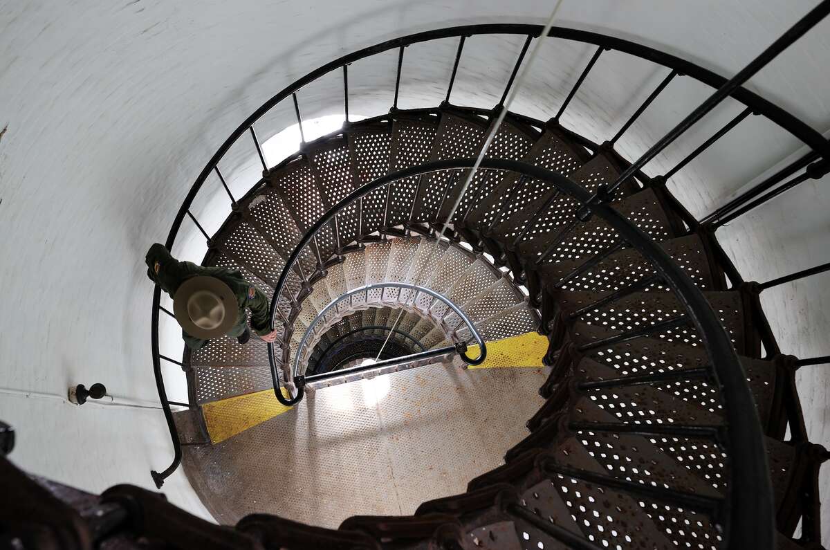 Interpreter manager Scott Shepherd descends stairs of the Pigeon Point Lighthouse as its 150th anniversary celebration is held on Nov. 12, 2022.