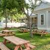 Picnic tables are placed on the lawn at1908 House of Wine & Ale in Cibolo, TX.