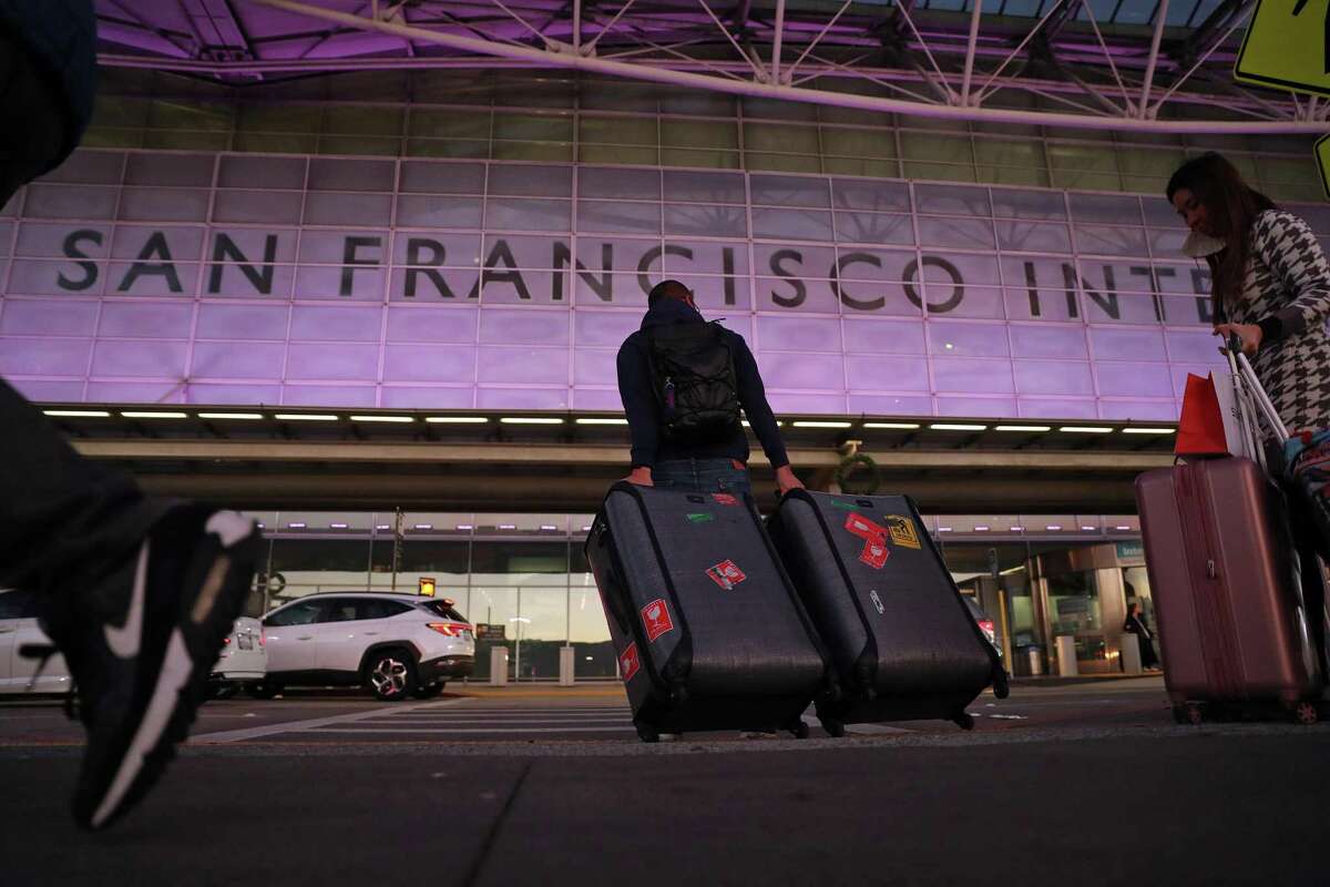 Travelers arrive Monday at the International Terminal at San Francisco International Airport.